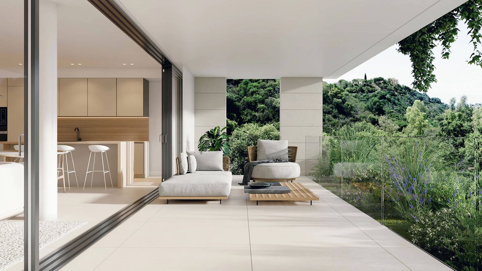 Modern living room with large glass windows, offering a scenic view of lush greenery.